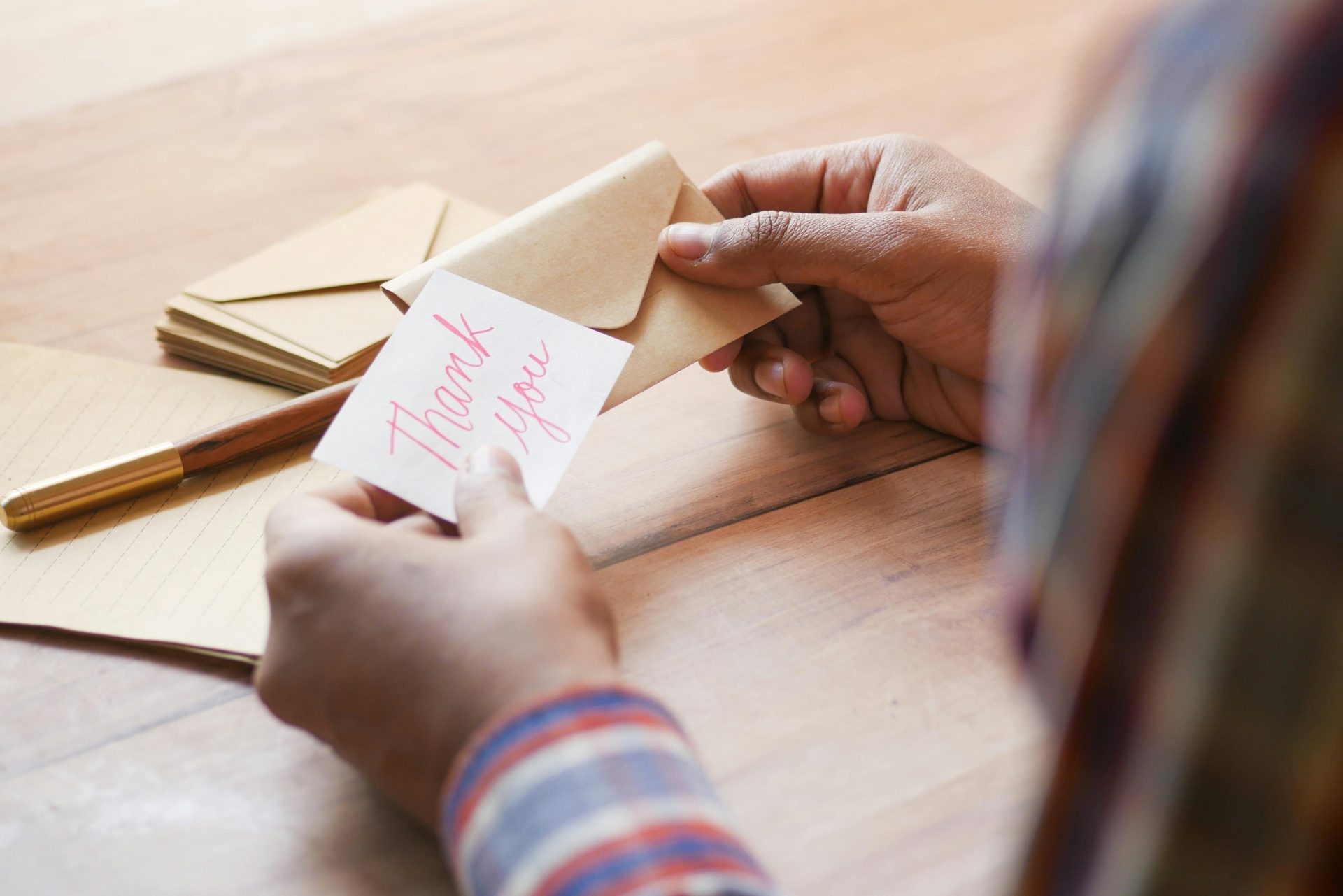 a person holds a Thank You card